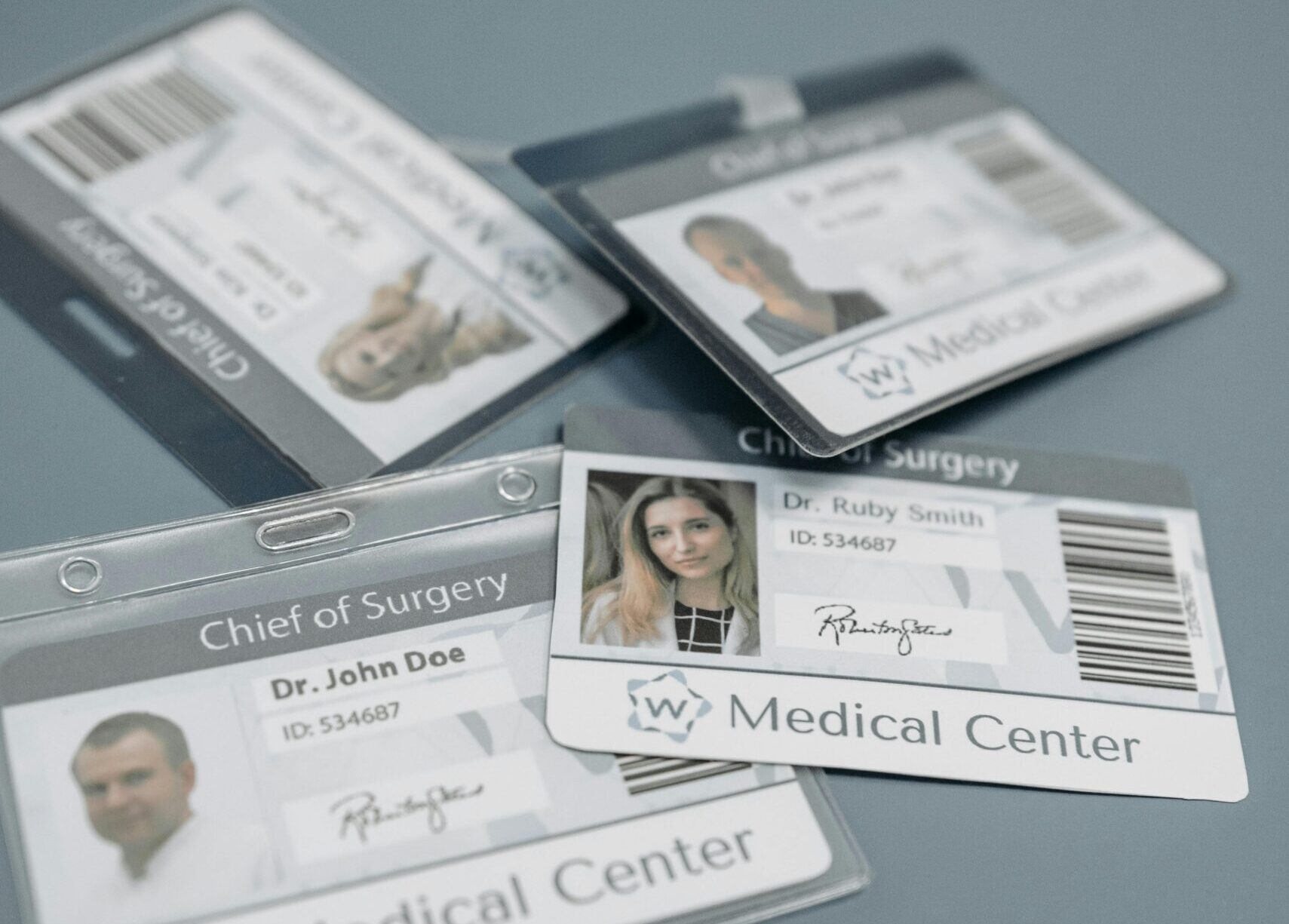 Close-up of medical ID badges featuring doctors from a healthcare center.